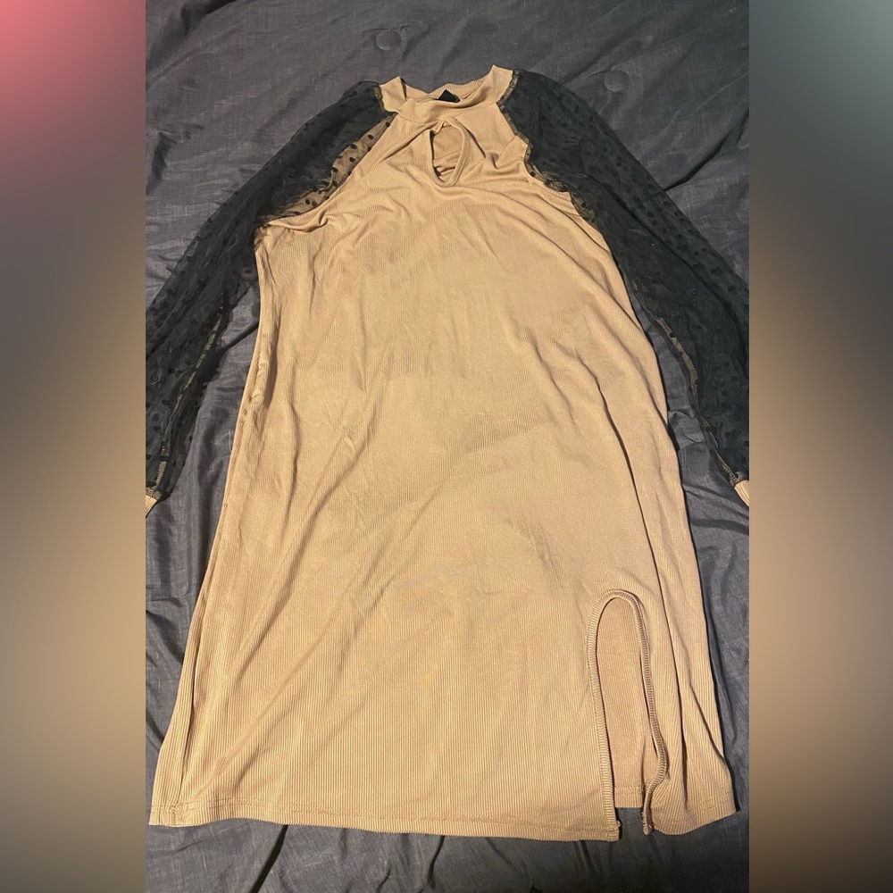 Tan dress,see through black dot arms. Has a little thigh slit in dress. Sexy